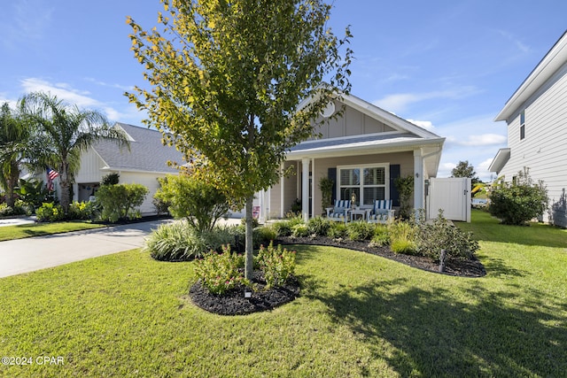 view of front of home with a front yard and a porch