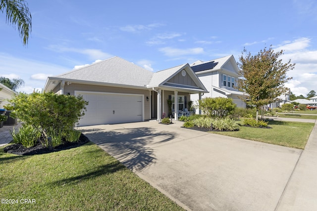 view of front of property with a garage and a front lawn