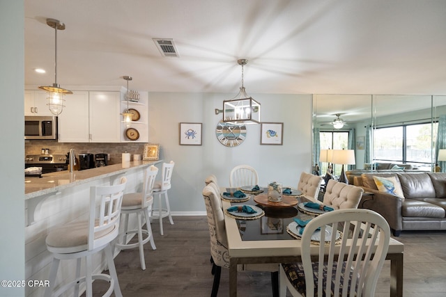 dining space featuring dark wood-type flooring