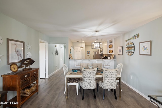 dining area with dark hardwood / wood-style flooring