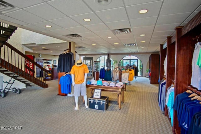 rec room with a paneled ceiling and carpet flooring