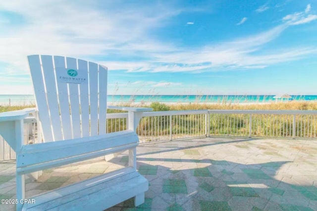 view of patio / terrace featuring a water view and a view of the beach