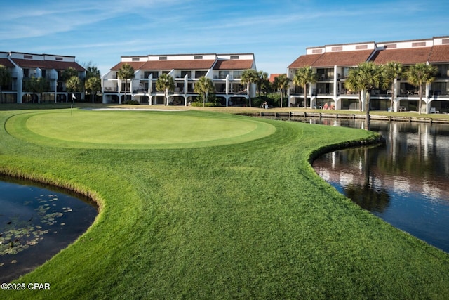 view of home's community featuring a water view and a yard