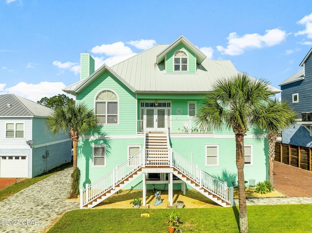 view of front of property featuring french doors and a front lawn