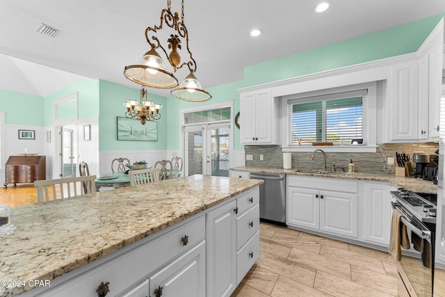 kitchen featuring a wealth of natural light, white cabinetry, sink, and appliances with stainless steel finishes