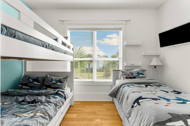 bedroom featuring light wood-type flooring and multiple windows