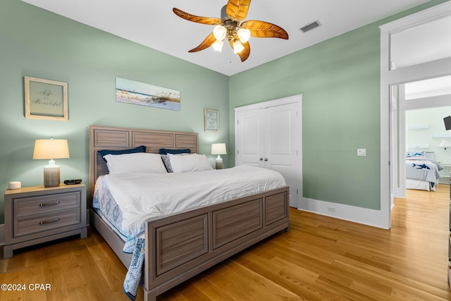 bedroom featuring ceiling fan, a closet, and light hardwood / wood-style flooring