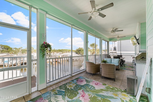 sunroom / solarium featuring ceiling fan