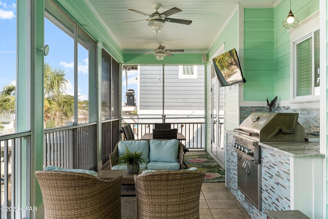 sunroom / solarium featuring ceiling fan