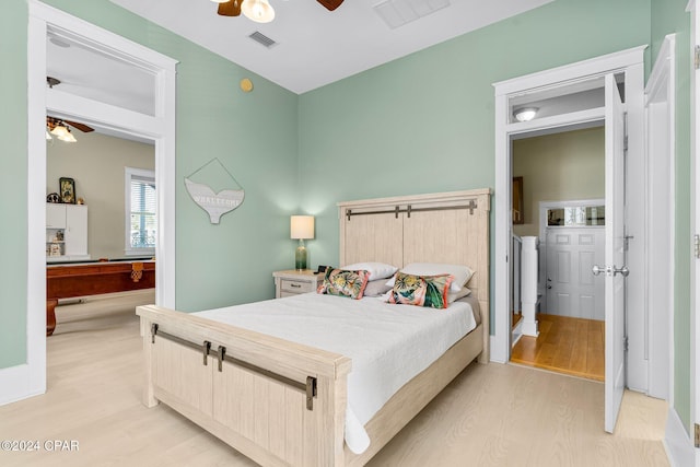 bedroom with light hardwood / wood-style floors and ceiling fan