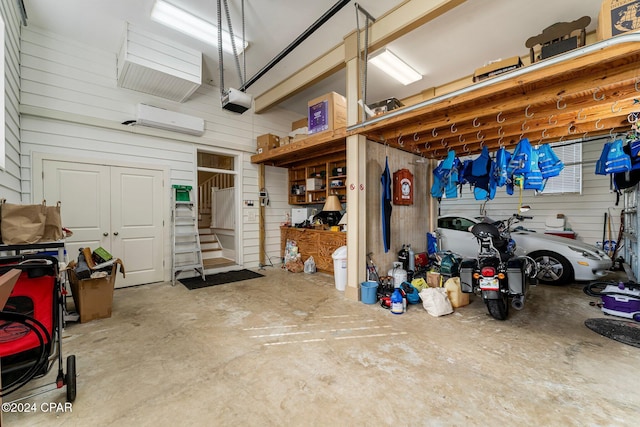 garage featuring wood walls and a garage door opener