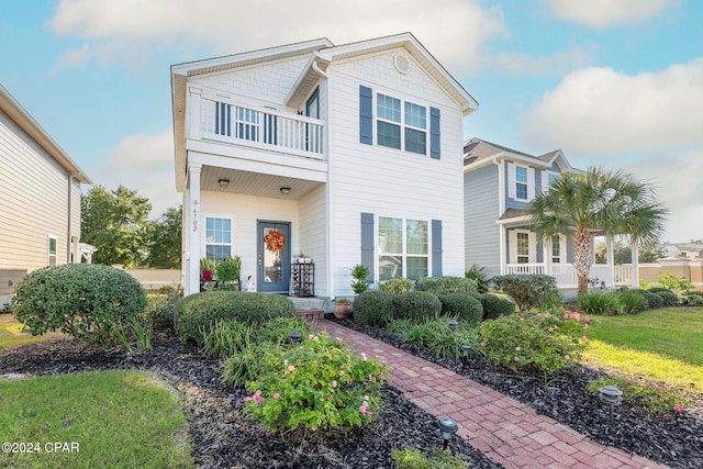 view of front of house with a balcony and covered porch