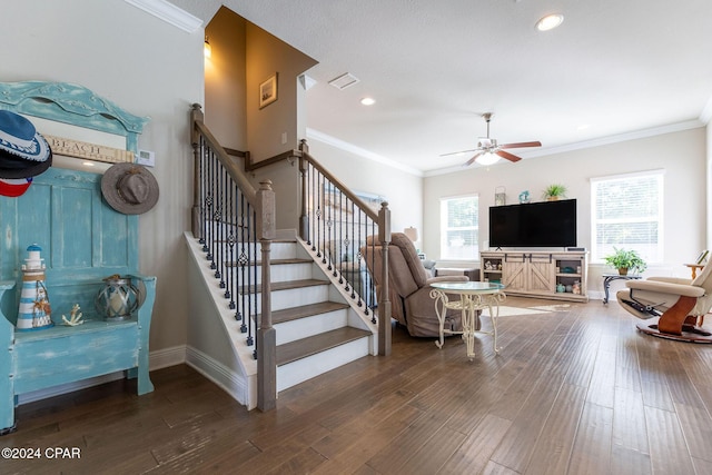 interior space featuring visible vents, crown molding, baseboards, and wood finished floors