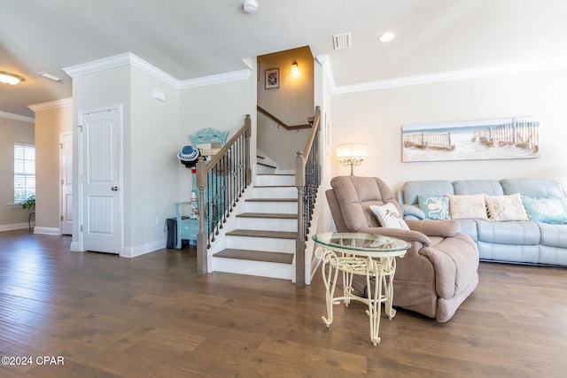 living room with visible vents, ornamental molding, wood finished floors, baseboards, and stairs