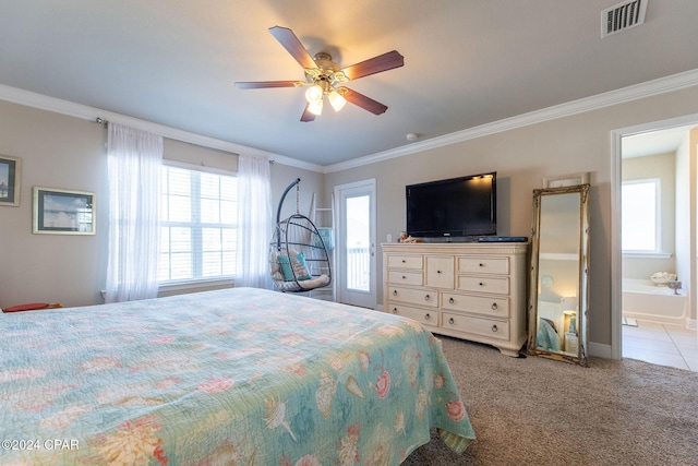 bedroom featuring crown molding, visible vents, a ceiling fan, light carpet, and ensuite bath