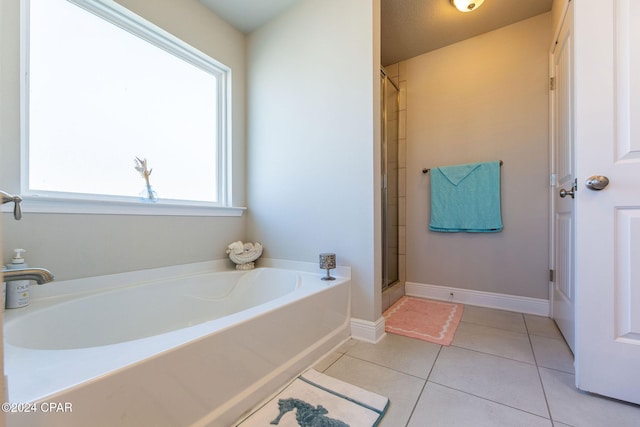 full bath with tile patterned flooring, a garden tub, baseboards, and an enclosed shower