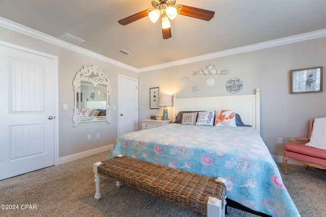 carpeted bedroom featuring baseboards, ceiling fan, visible vents, and crown molding