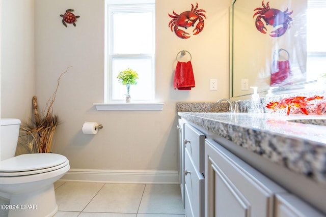 bathroom featuring baseboards, vanity, toilet, and tile patterned floors