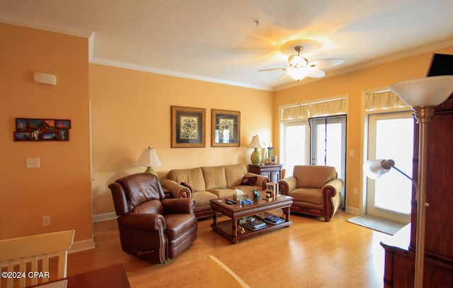 living room featuring crown molding, light hardwood / wood-style flooring, and ceiling fan