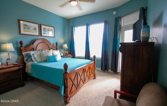 bedroom featuring ceiling fan and light carpet