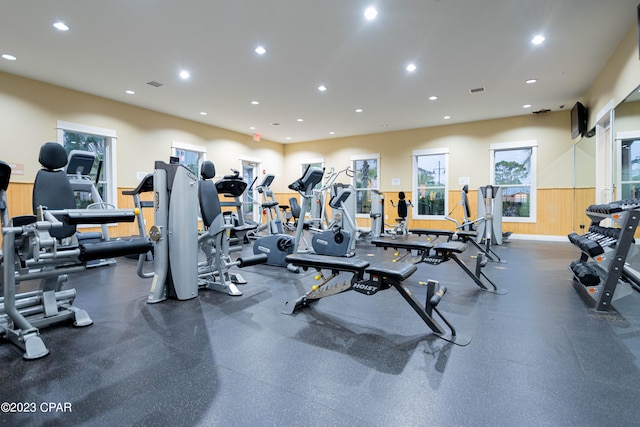 exercise room with wood walls