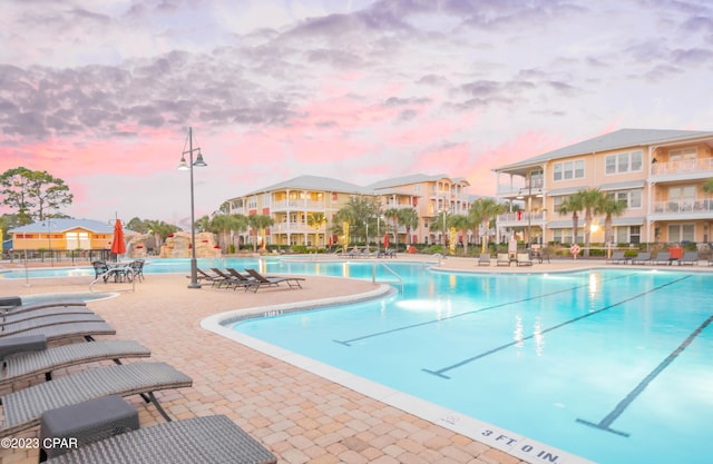 pool at dusk with a patio