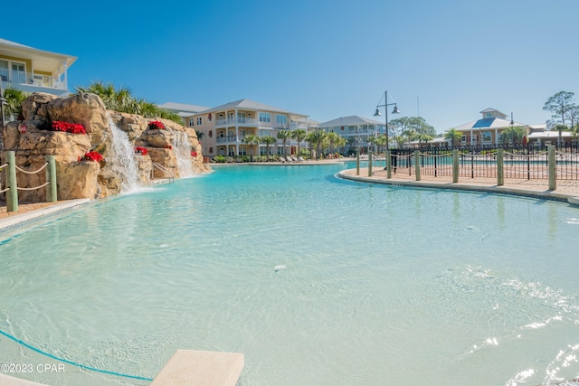 view of swimming pool with pool water feature