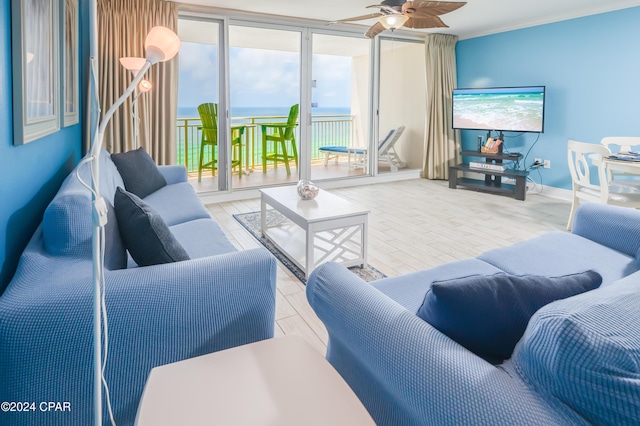 living room featuring ceiling fan, expansive windows, and a healthy amount of sunlight