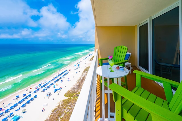 balcony featuring a water view and a view of the beach