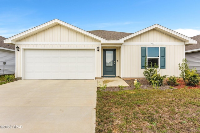 single story home featuring a garage and a front lawn