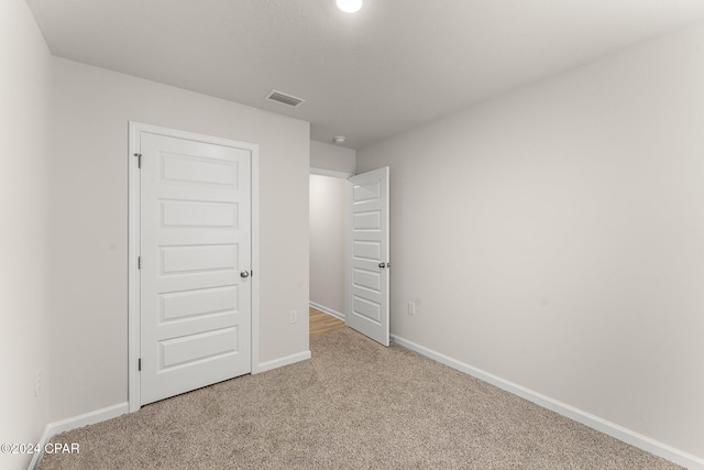 unfurnished bedroom with carpet and a closet