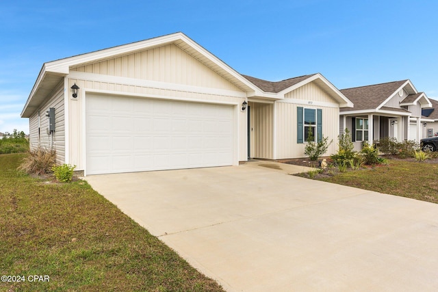 ranch-style house with a front yard and a garage