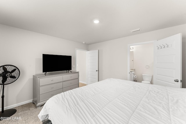 carpeted bedroom featuring ensuite bathroom