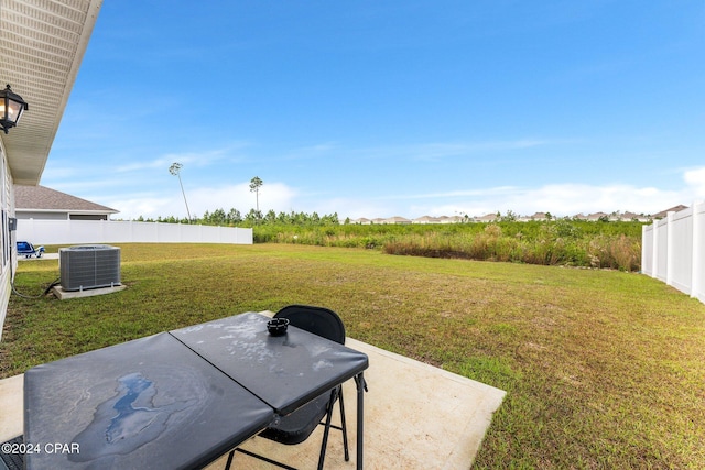 view of yard featuring central air condition unit and a patio area