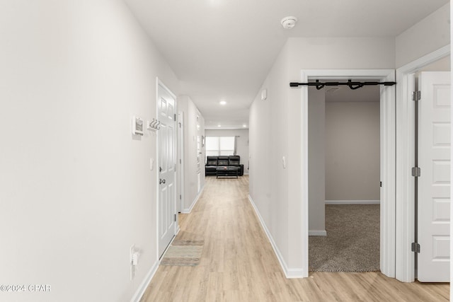 hall with light hardwood / wood-style flooring