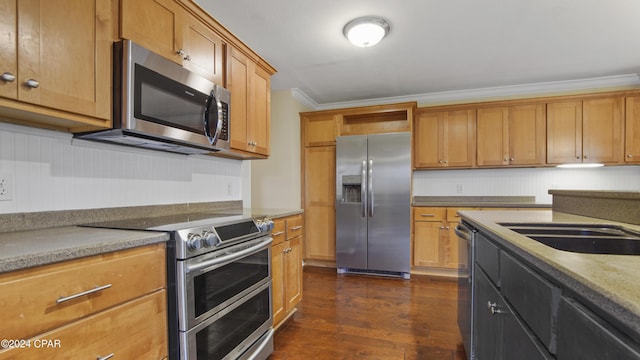 kitchen featuring light stone countertops, dark wood-type flooring, stainless steel appliances, sink, and ornamental molding