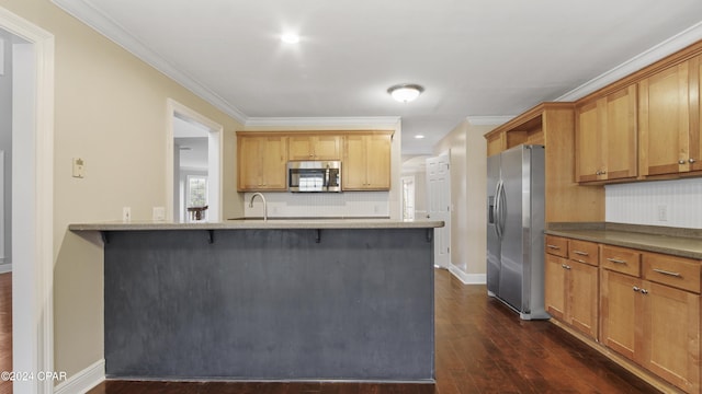 kitchen featuring decorative backsplash, kitchen peninsula, crown molding, dark wood-type flooring, and appliances with stainless steel finishes