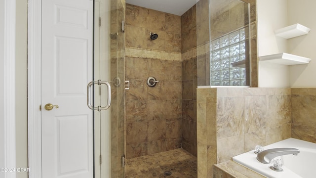 bathroom with shower with separate bathtub