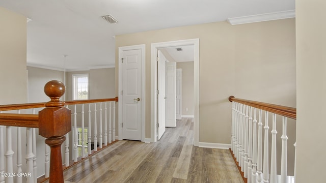 corridor featuring light hardwood / wood-style flooring and ornamental molding