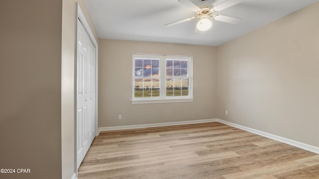 unfurnished bedroom with ceiling fan, light hardwood / wood-style floors, and a closet