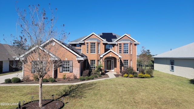 craftsman house with a front yard and solar panels