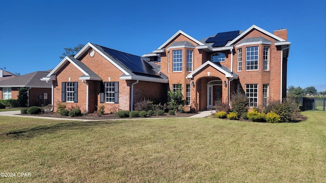 craftsman house with a front yard and solar panels