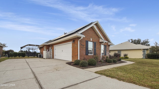 view of side of property featuring a lawn, central AC, solar panels, and a garage