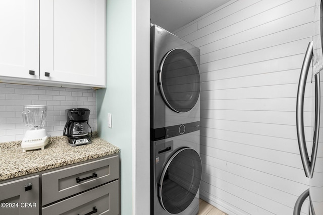 laundry room featuring stacked washer and clothes dryer