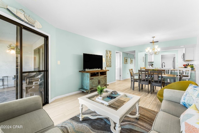 living room featuring sink and a chandelier