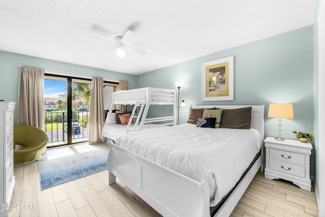 bedroom featuring access to exterior, ceiling fan, and a textured ceiling