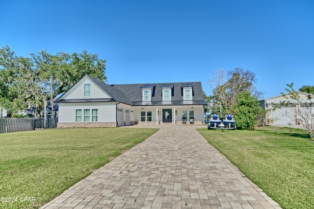 view of front facade featuring a garage, covered porch, and a front lawn