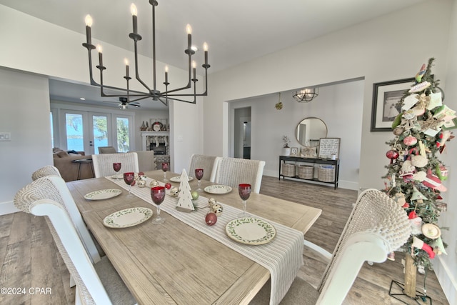 dining space featuring french doors, ceiling fan, and wood-type flooring