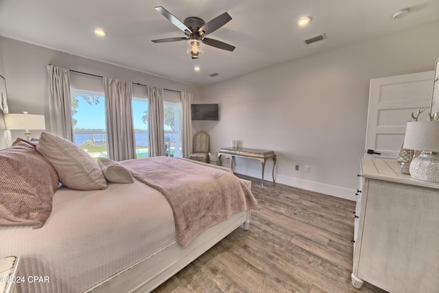 bedroom with ceiling fan and wood-type flooring