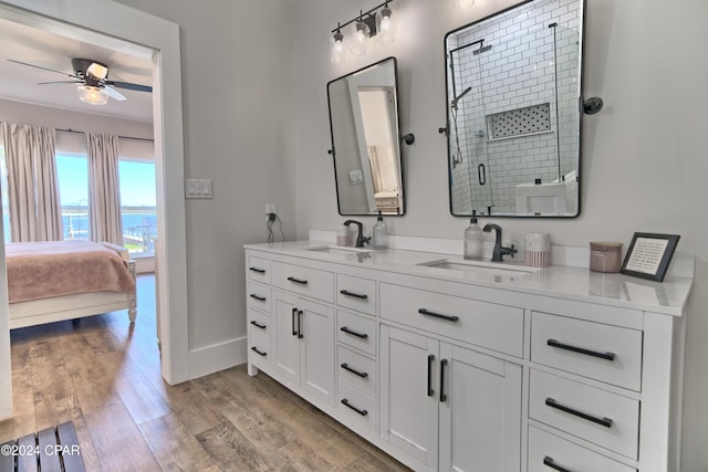 bathroom featuring an enclosed shower, wood-type flooring, vanity, and ceiling fan